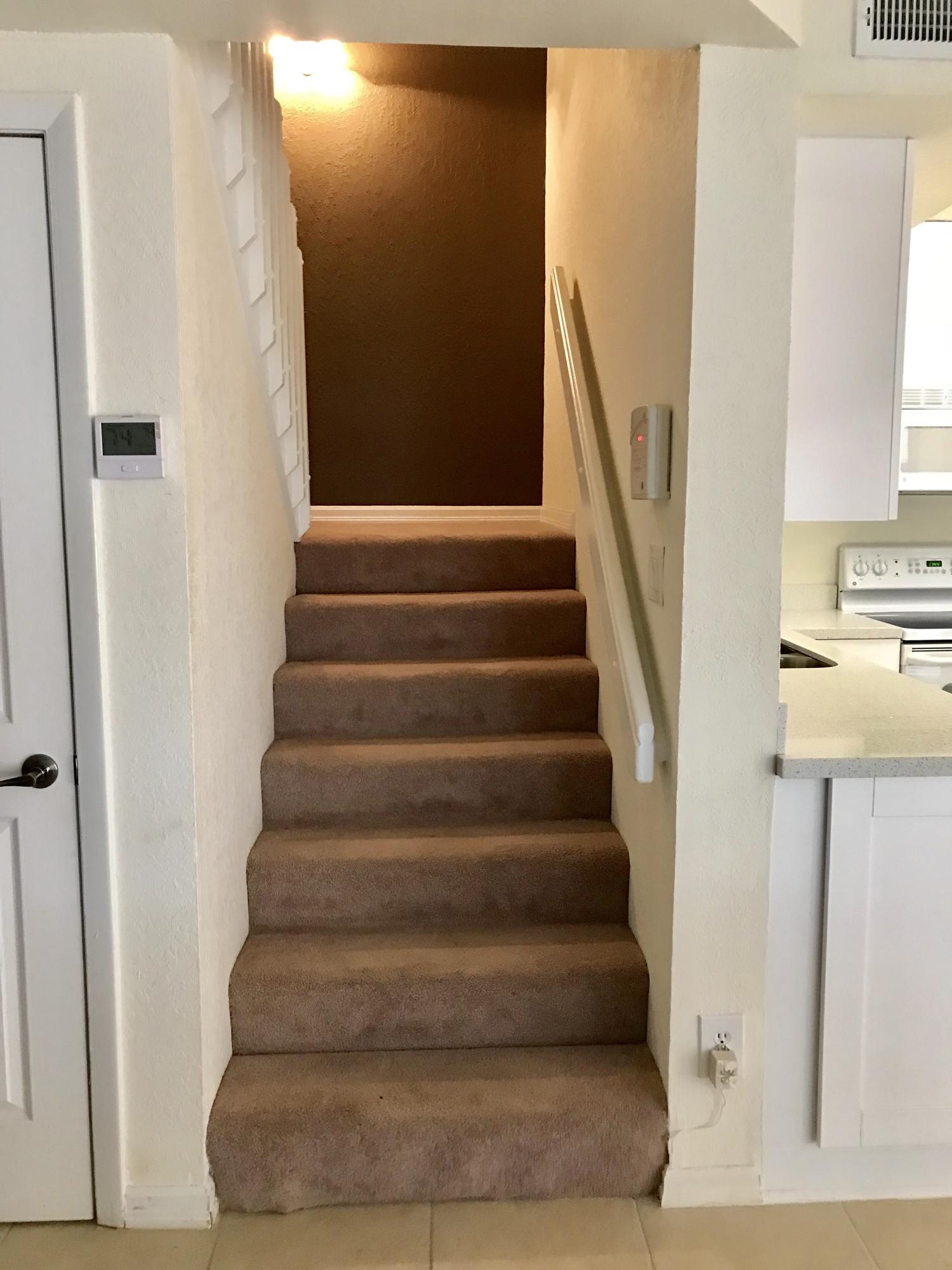 8249 Thames Boulevard, Unit B Boca Raton, FL 33433 - Photo 15 of 46 a view of staircase with white walls and windows