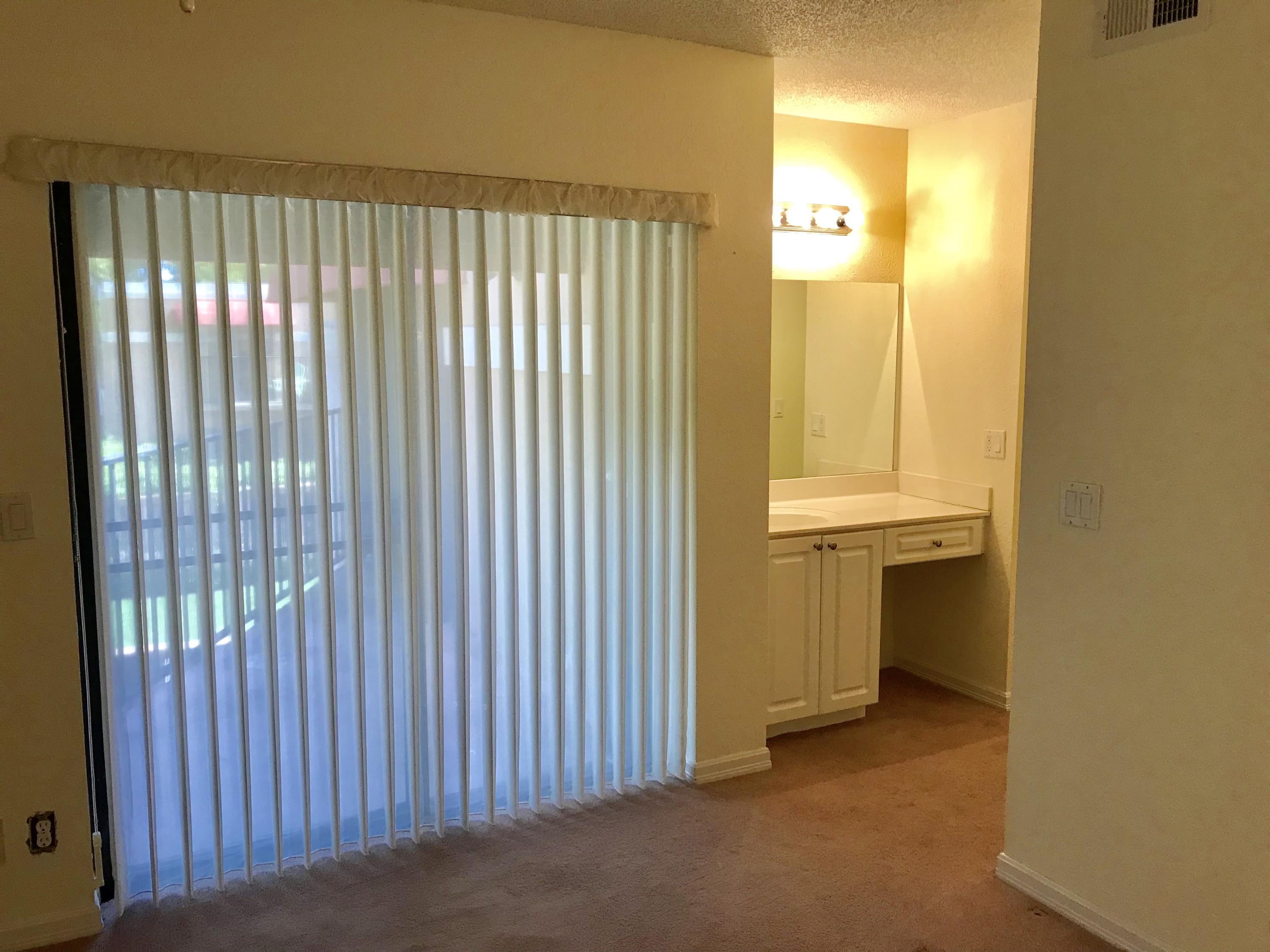 8249 Thames Boulevard, Unit B Boca Raton, FL 33433 - Photo 20 of 46 a view of a bathroom with sliding door and tree