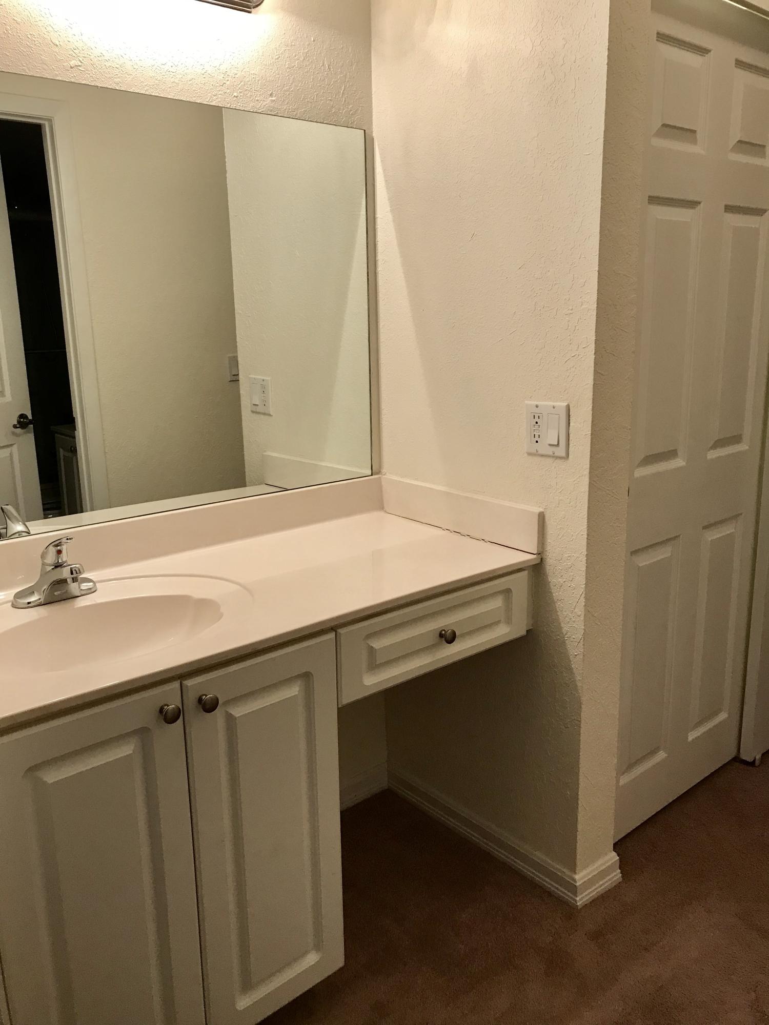 8249 Thames Boulevard, Unit B Boca Raton, FL 33433 - Photo 23 of 46 a bathroom with a sink and a mirror