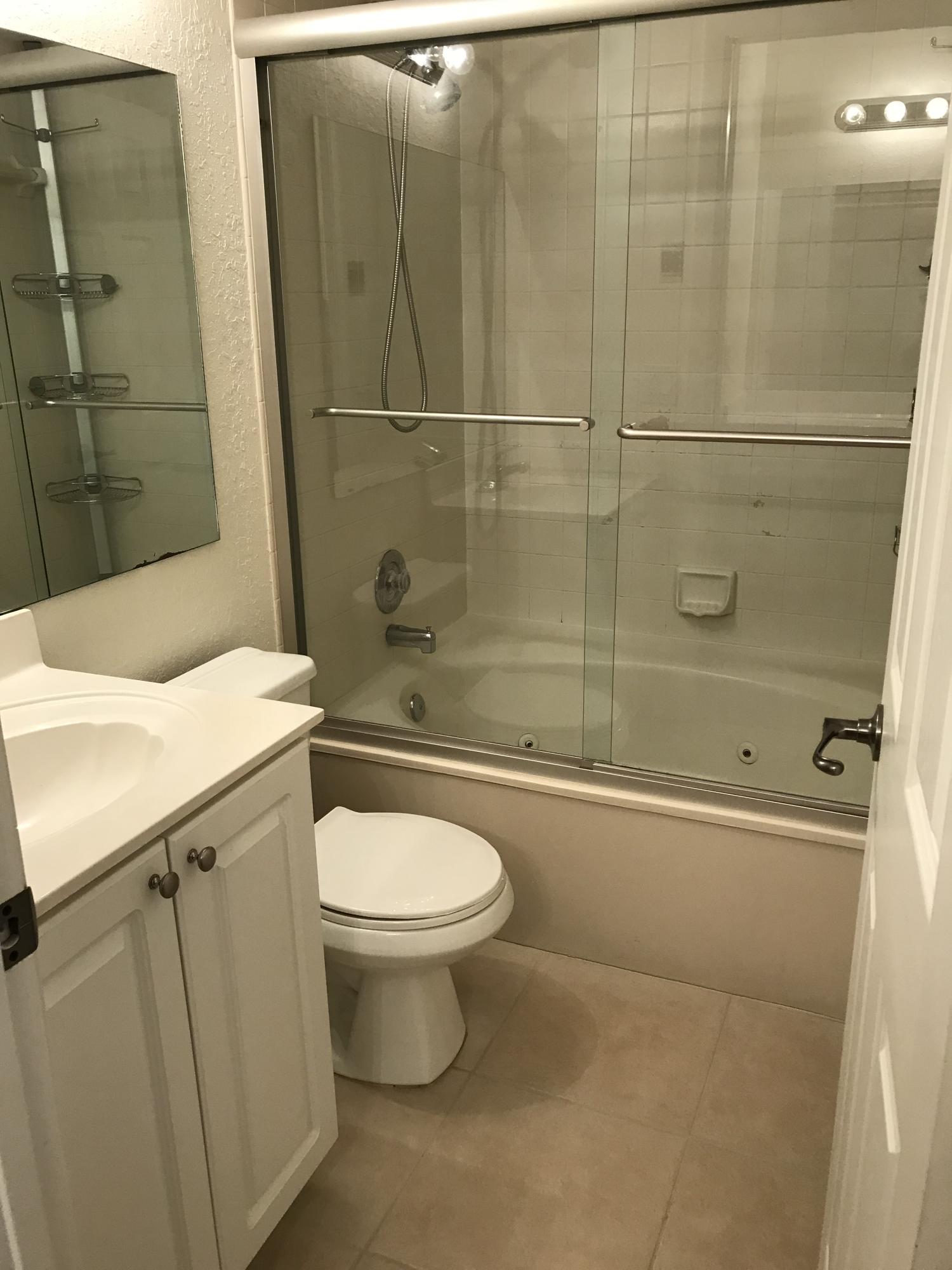 8249 Thames Boulevard, Unit B Boca Raton, FL 33433 - Photo 25 of 46 a bathroom with a sink toilet and shower