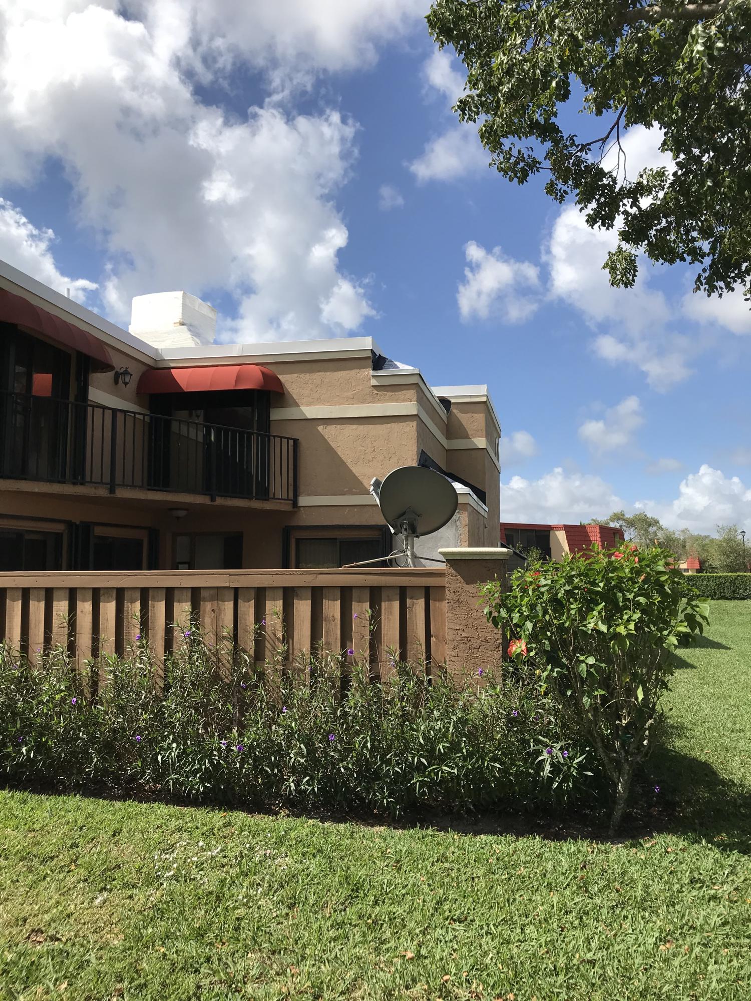 8249 Thames Boulevard, Unit B Boca Raton, FL 33433 - Photo 33 of 46 a view of a brick house with a yard