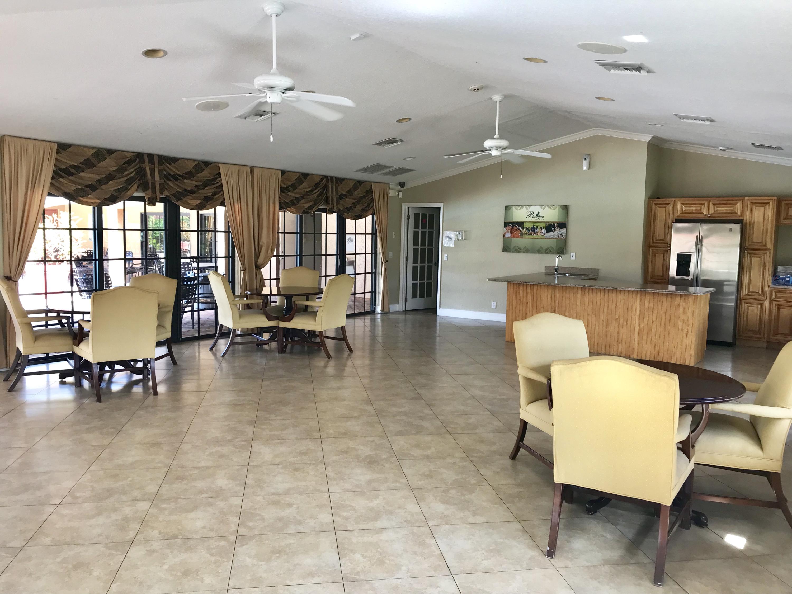 8249 Thames Boulevard, Unit B Boca Raton, FL 33433 - Photo 42 of 46 a living room with furniture and a dining table