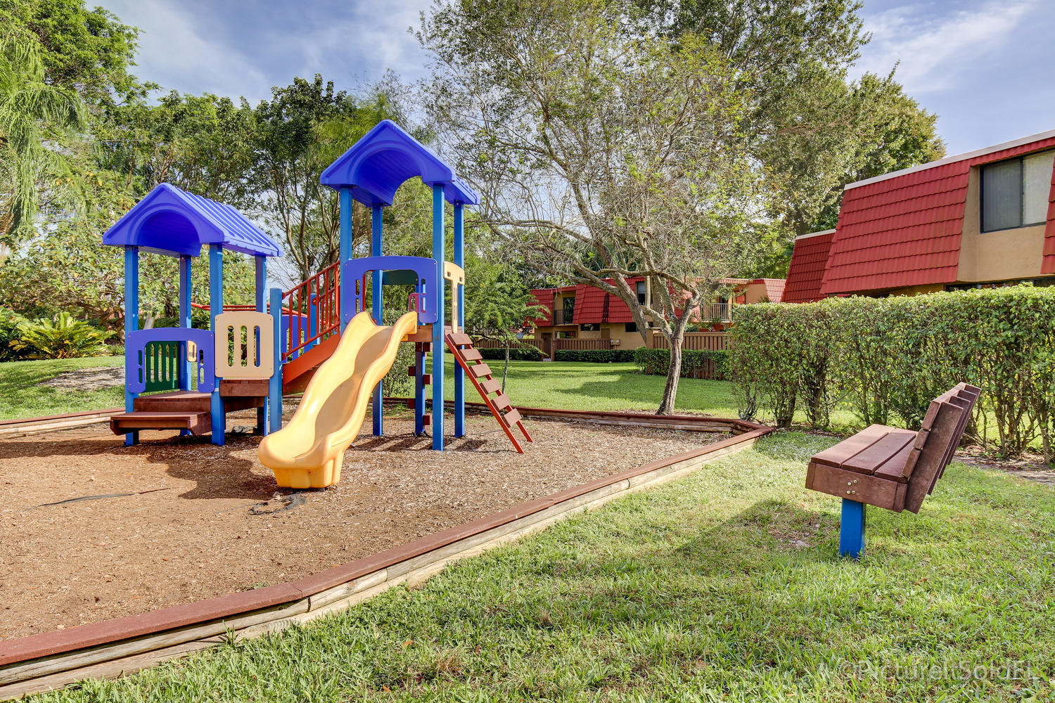 8249 Thames Boulevard, Unit B Boca Raton, FL 33433 - Photo 43 of 46 a view of a park with slide and a bench