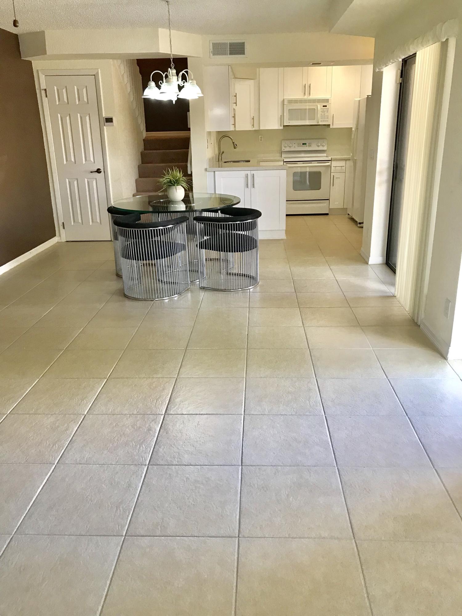 8249 Thames Boulevard, Unit B Boca Raton, FL 33433 - Photo 7 of 46 a kitchen with stainless steel appliances granite countertop a stove a refrigerator and a counter top space