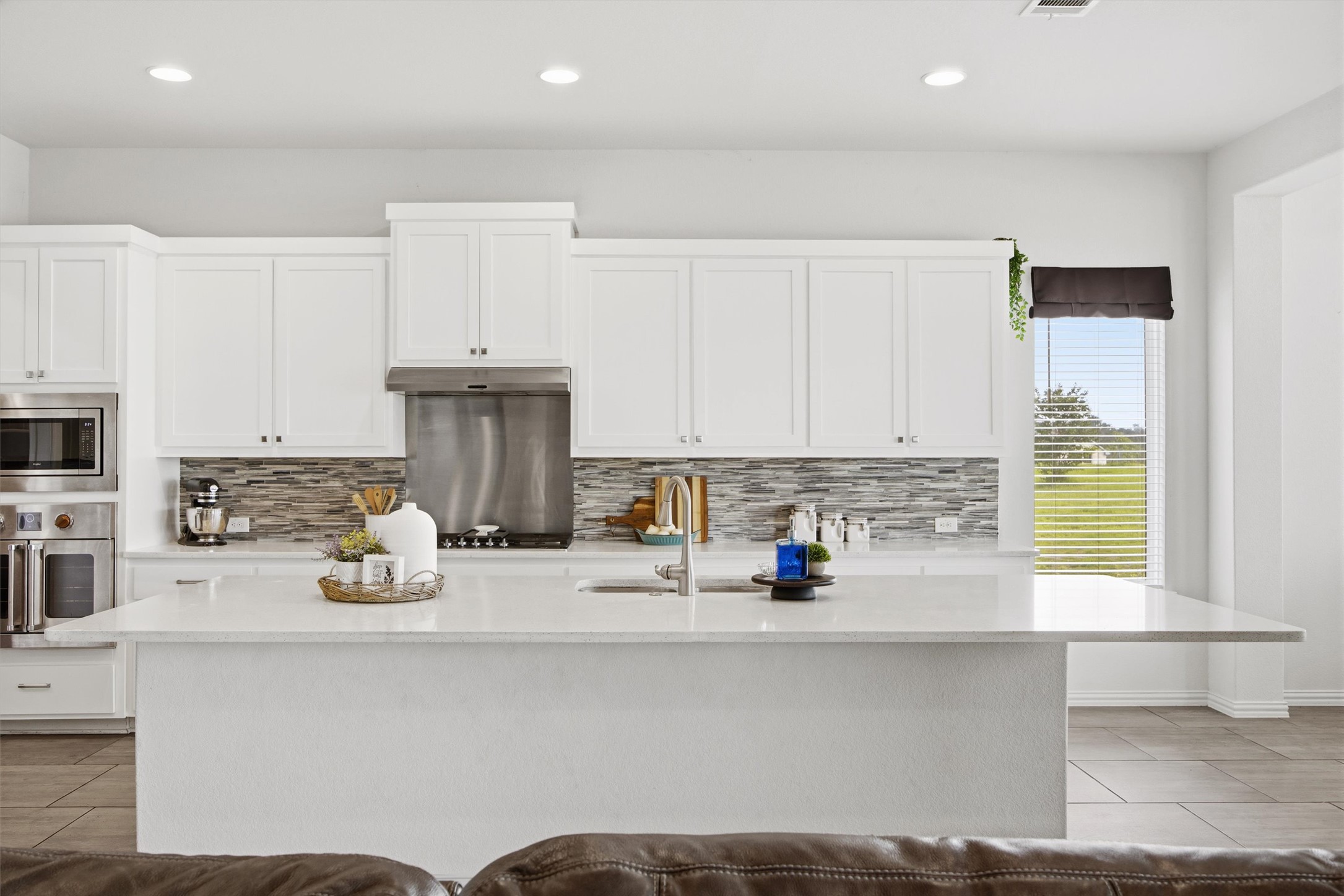 192 Raptor Beak Way Cedar Creek, TX 78612 - Photo 8 of 38 Spacious kitchen island featuring a light stone countertop and integrated sink