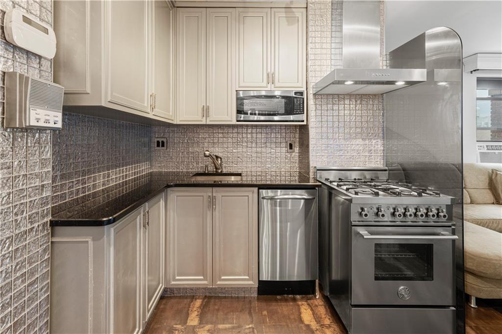 2615 Avenue O, Unit 6C Brooklyn, NY 11210 - Photo 1 of 10 a kitchen with granite countertop a stove sink and cabinets