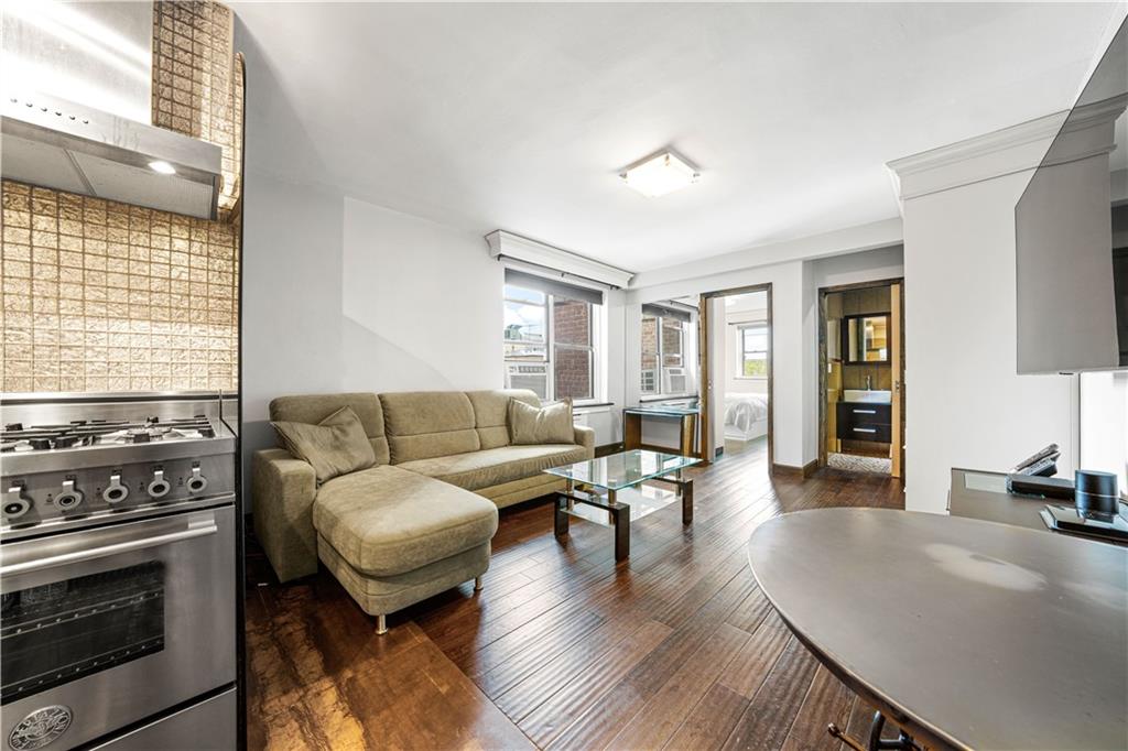 2615 Avenue O, Unit 6C Brooklyn, NY 11210 - Photo 4 of 10 a living room with furniture a fireplace and wooden floor