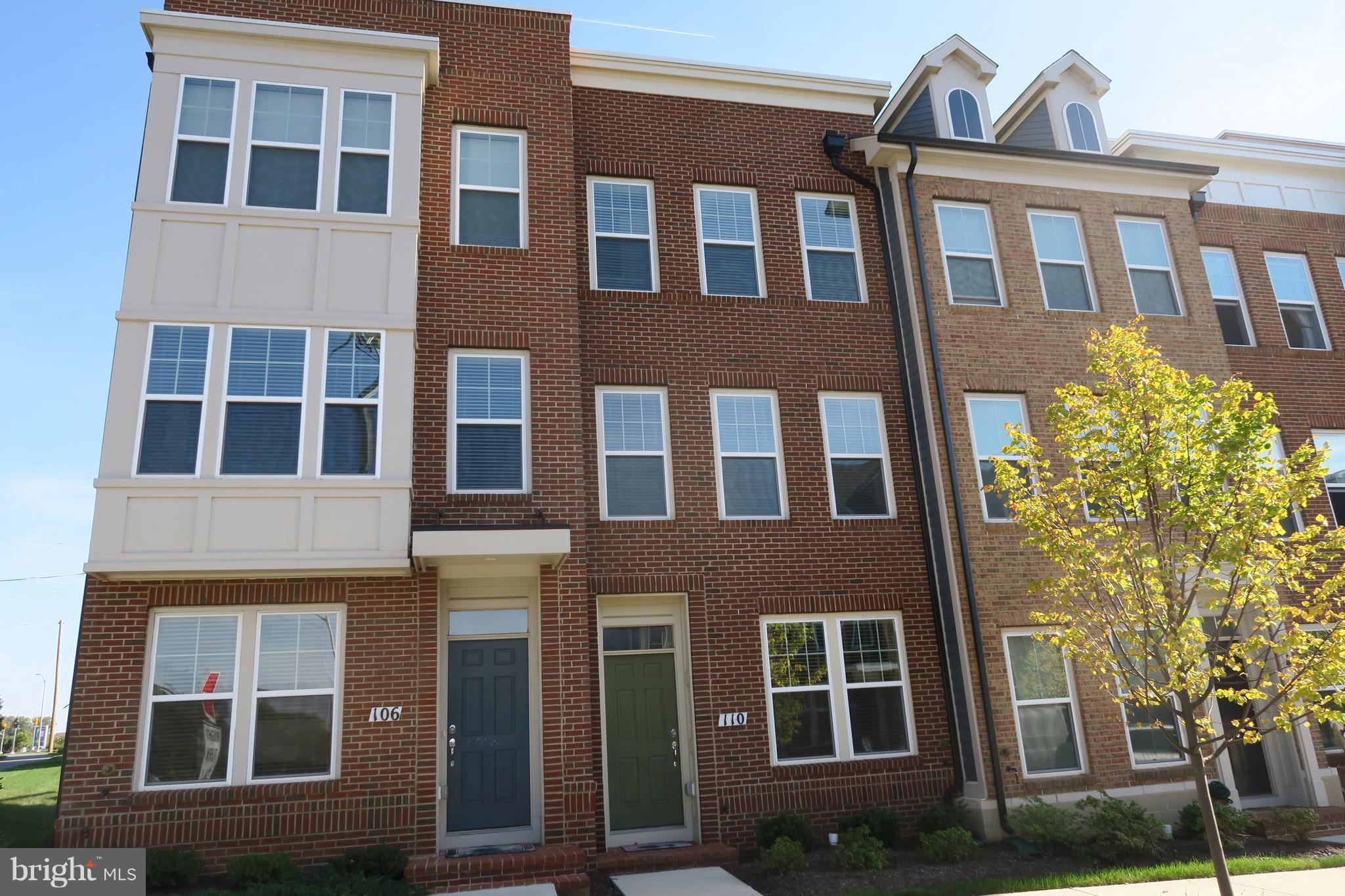 110 Strummer Lane Gaithersburg, MD 20878 - Photo 1 of 22 a front view of a building with a garden
