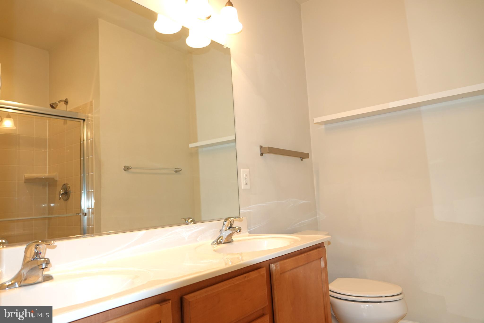 110 Strummer Lane Gaithersburg, MD 20878 - Photo 13 of 22 a bathroom with a sink a toilet and shower