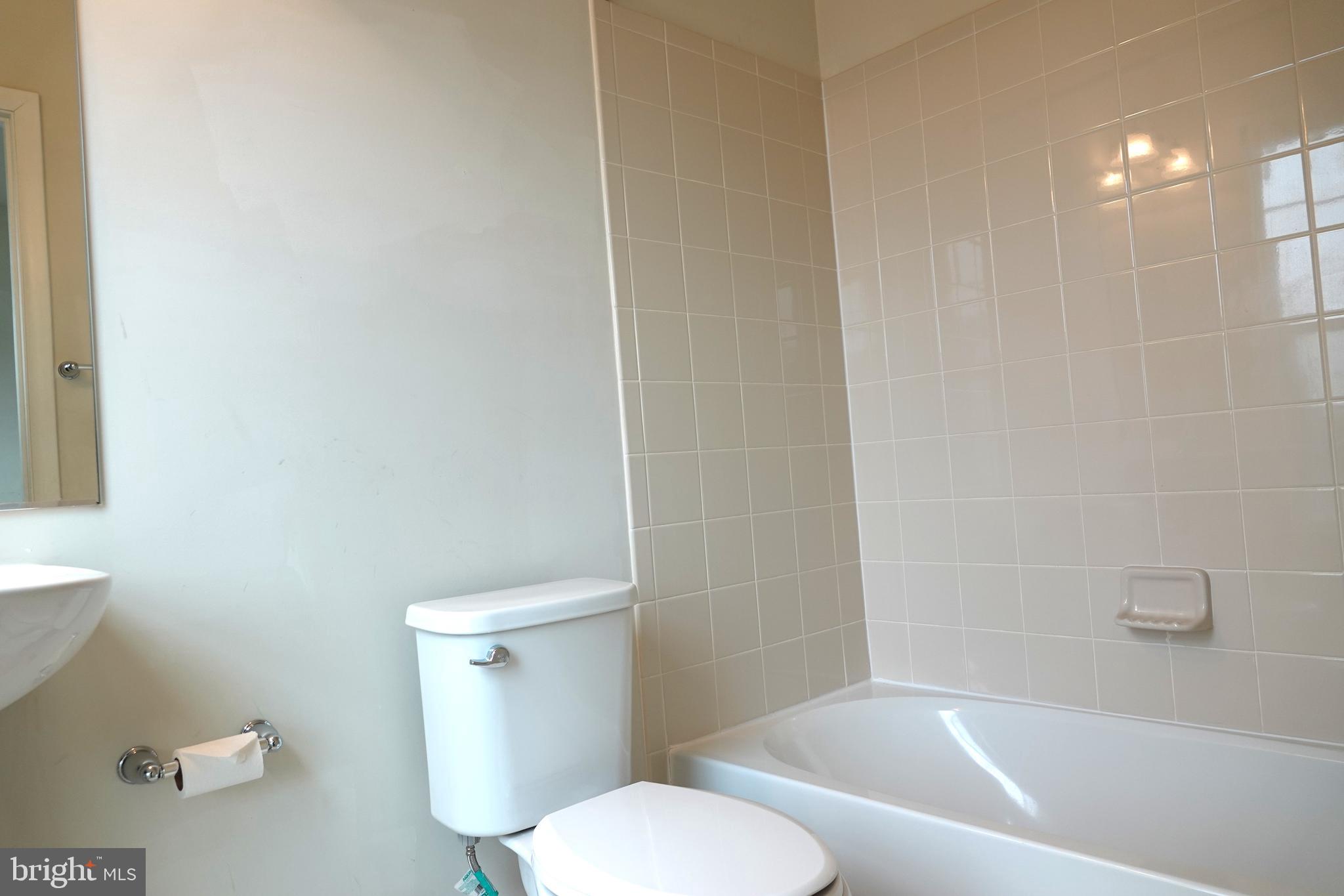 110 Strummer Lane Gaithersburg, MD 20878 - Photo 17 of 22 a white toilet and tub sitting next to a bathroom sink