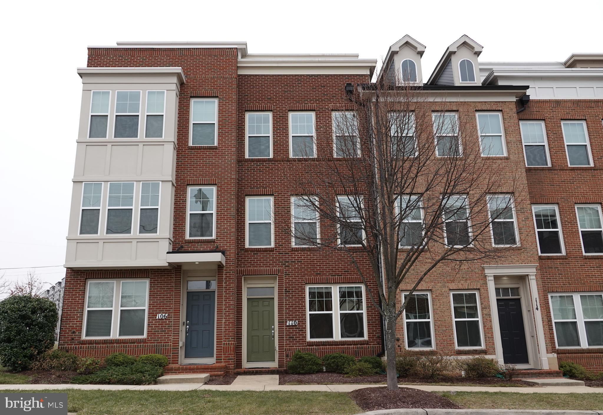 110 Strummer Lane Gaithersburg, MD 20878 - Photo 2 of 22 a front view of a building with a yard