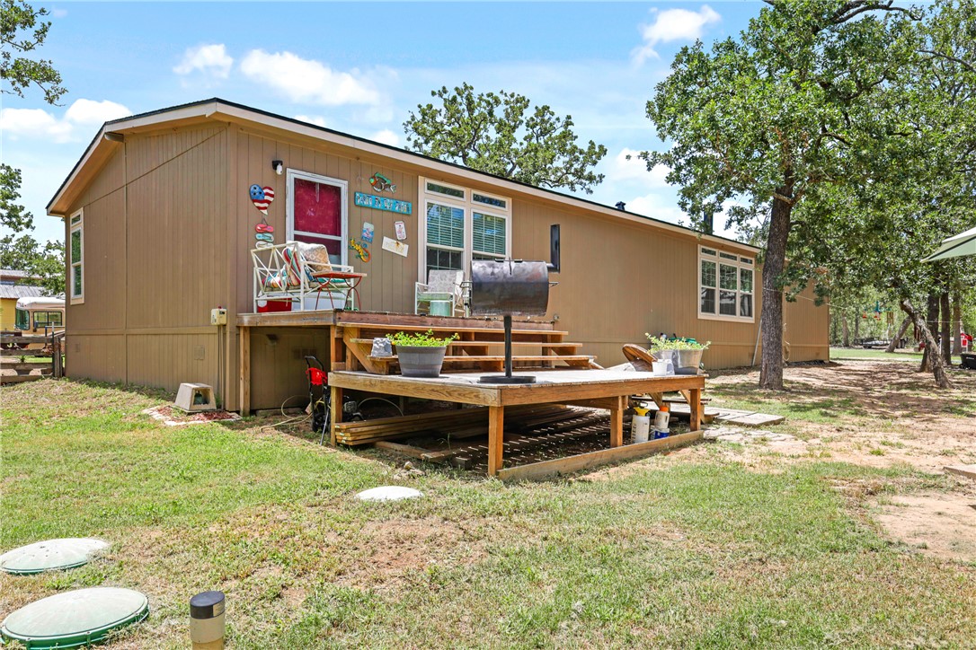 735 Boysenberry Road Somerville, TX 77879 - Photo 17 of 27 a backyard of a house with table and chairs