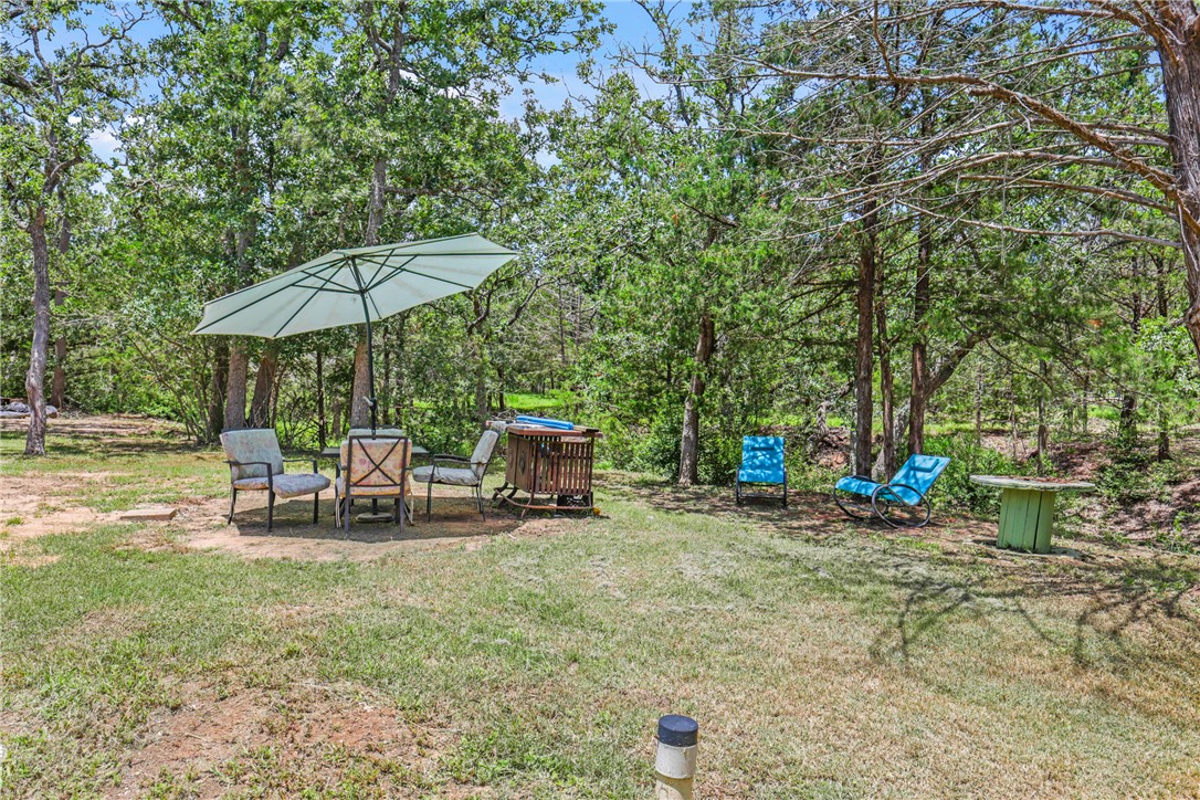 735 Boysenberry Road Somerville, TX 77879 - Photo 18 of 27 a view of a outdoor space with furniture and umbrella