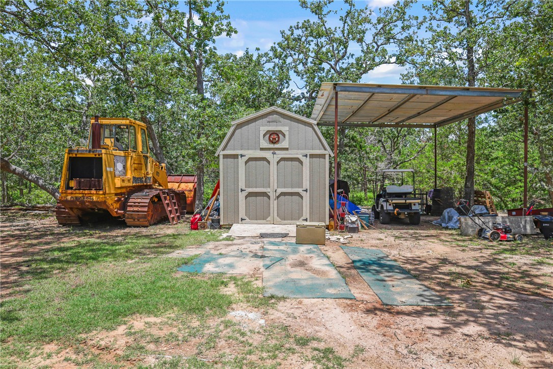 735 Boysenberry Road Somerville, TX 77879 - Photo 19 of 27 a front view of a house with a large tree and many windows