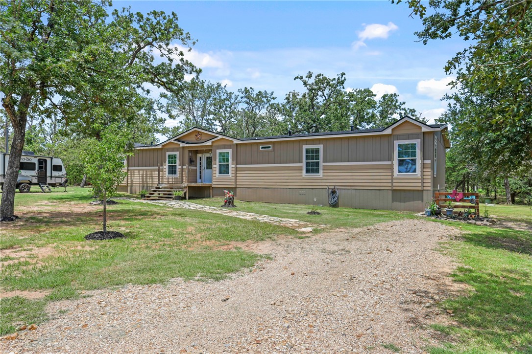 735 Boysenberry Road Somerville, TX 77879 - Photo 2 of 27 a front view of house with yard and green space