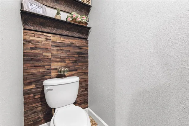 a bathroom with a toilet and a shower curtain