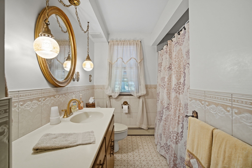 43 Greenleaf Avenue West Springfield, MA 01089 - Photo 17 of 37 a bathroom with a granite countertop sink and a mirror