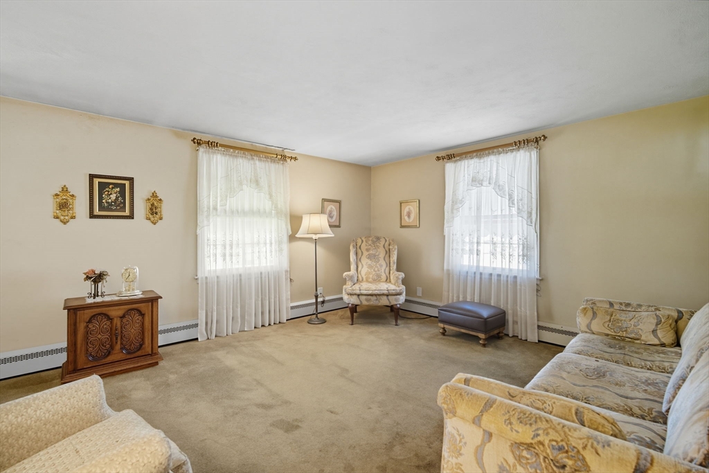43 Greenleaf Avenue West Springfield, MA 01089 - Photo 6 of 37 a living room with furniture a window and gym equipment