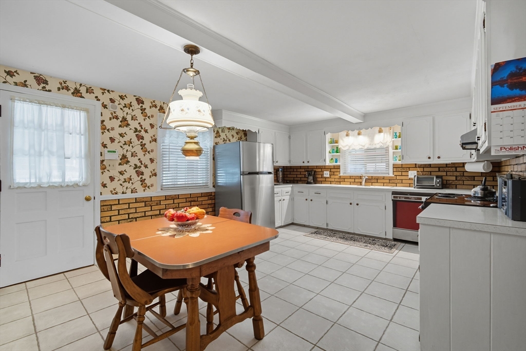 43 Greenleaf Avenue West Springfield, MA 01089 - Photo 9 of 37 a kitchen with stainless steel appliances kitchen island granite countertop a table chairs sink and cabinets