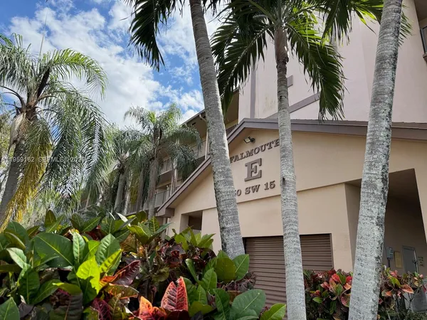 a view of a house with a palm tree