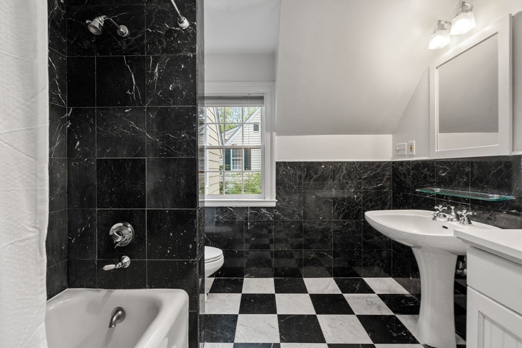 33 Manchester Road Newton, MA 02461 - Photo 23 of 31 a bathroom with a sink a toilet and a bathtub