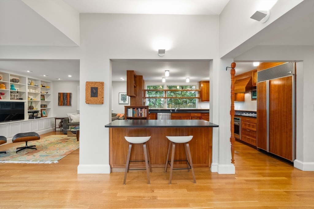 33 Manchester Road Newton, MA 02461 - Photo 10 of 31 a dining hall with stainless steel appliances granite countertop a table and chairs a refrigerator with wooden floor