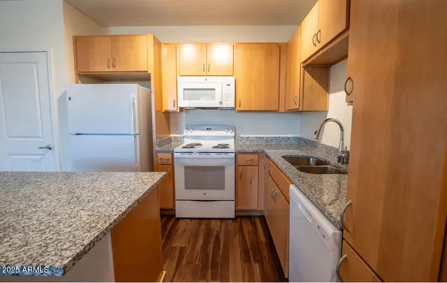 a kitchen with a sink stove and refrigerator