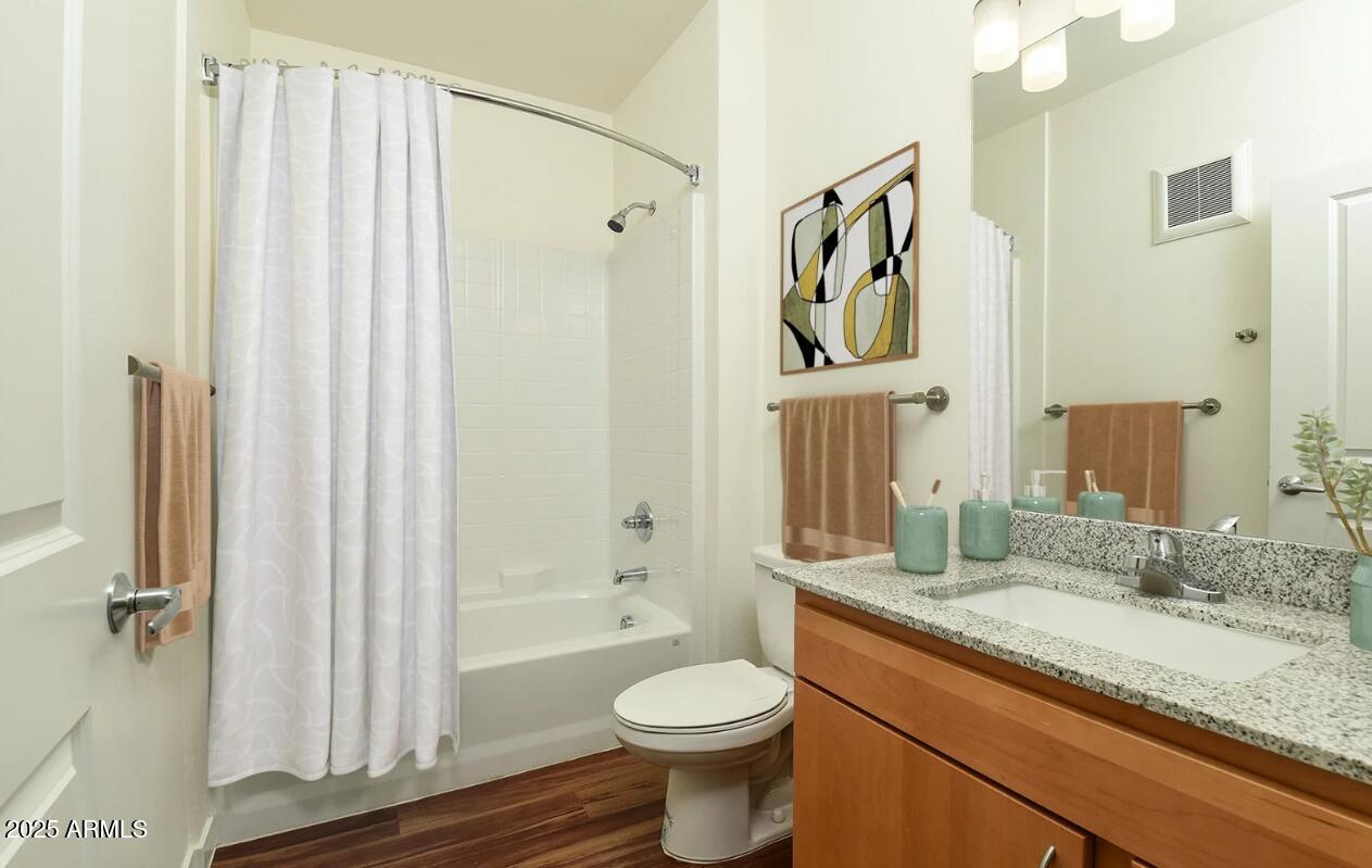 7800 West Encanto Boulevard, Unit 2 Phoenix, AZ 85035 - Photo 6 of 14 a bathroom with a granite countertop toilet sink and shower