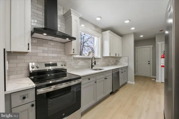 a kitchen with a sink stove and cabinets