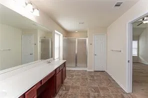 a spacious bathroom with a shower and a sink