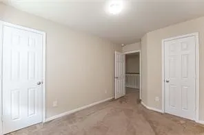 a view of an empty room with closet area