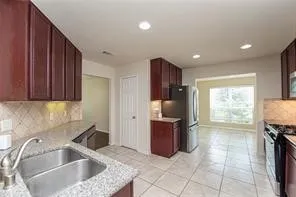 a kitchen with a sink and a refrigerator