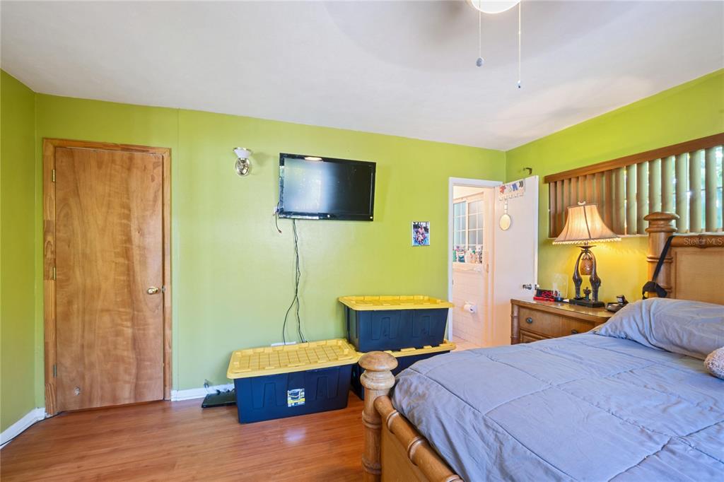 820 3rd Avenue Southwest Largo, FL 33770 - Photo 11 of 25 a bedroom with a bed and wooden floor