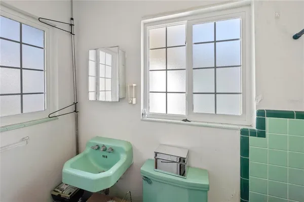 a bathroom with a sink and a window