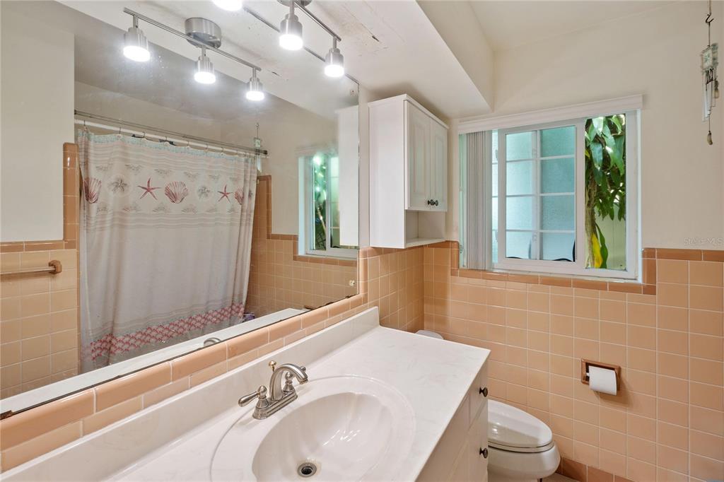 820 3rd Avenue Southwest Largo, FL 33770 - Photo 18 of 25 a bathroom with a sink a toilet and shower