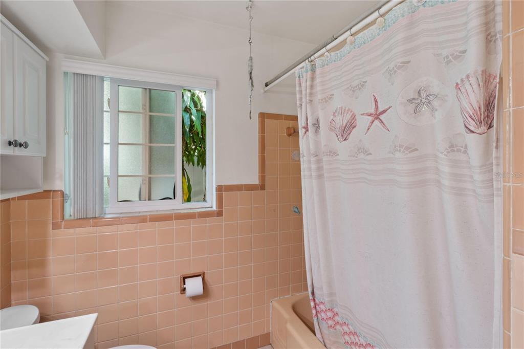 820 3rd Avenue Southwest Largo, FL 33770 - Photo 19 of 25 a bathroom with a bathtub and shower