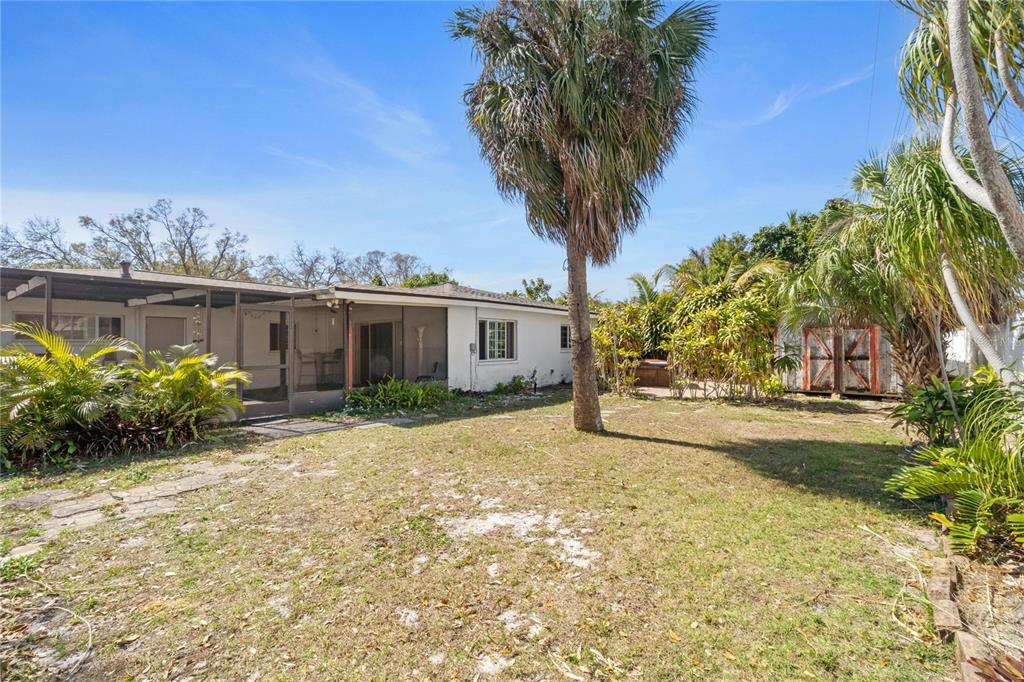 820 3rd Avenue Southwest Largo, FL 33770 - Photo 22 of 25 a view of a house with a yard and potted plants