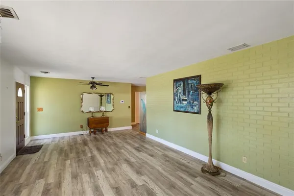 a view of a bedroom with wooden floor