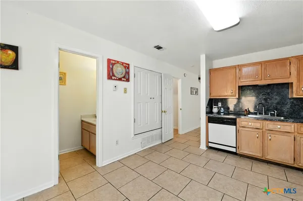a kitchen with granite countertop cabinets and white appliances