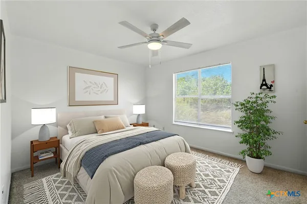 a bedroom with a bed and a potted plant