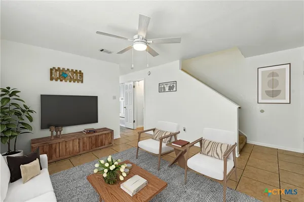 a living room with furniture and a flat screen tv