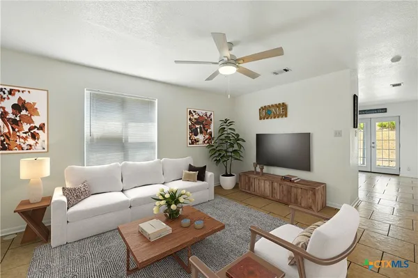 a living room with furniture and a flat screen tv
