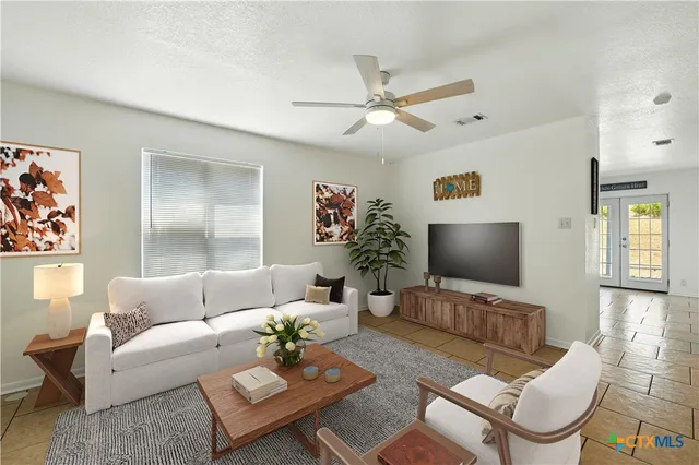 a kitchen with stainless steel appliances granite countertop a refrigerator sink stove and white cabinets