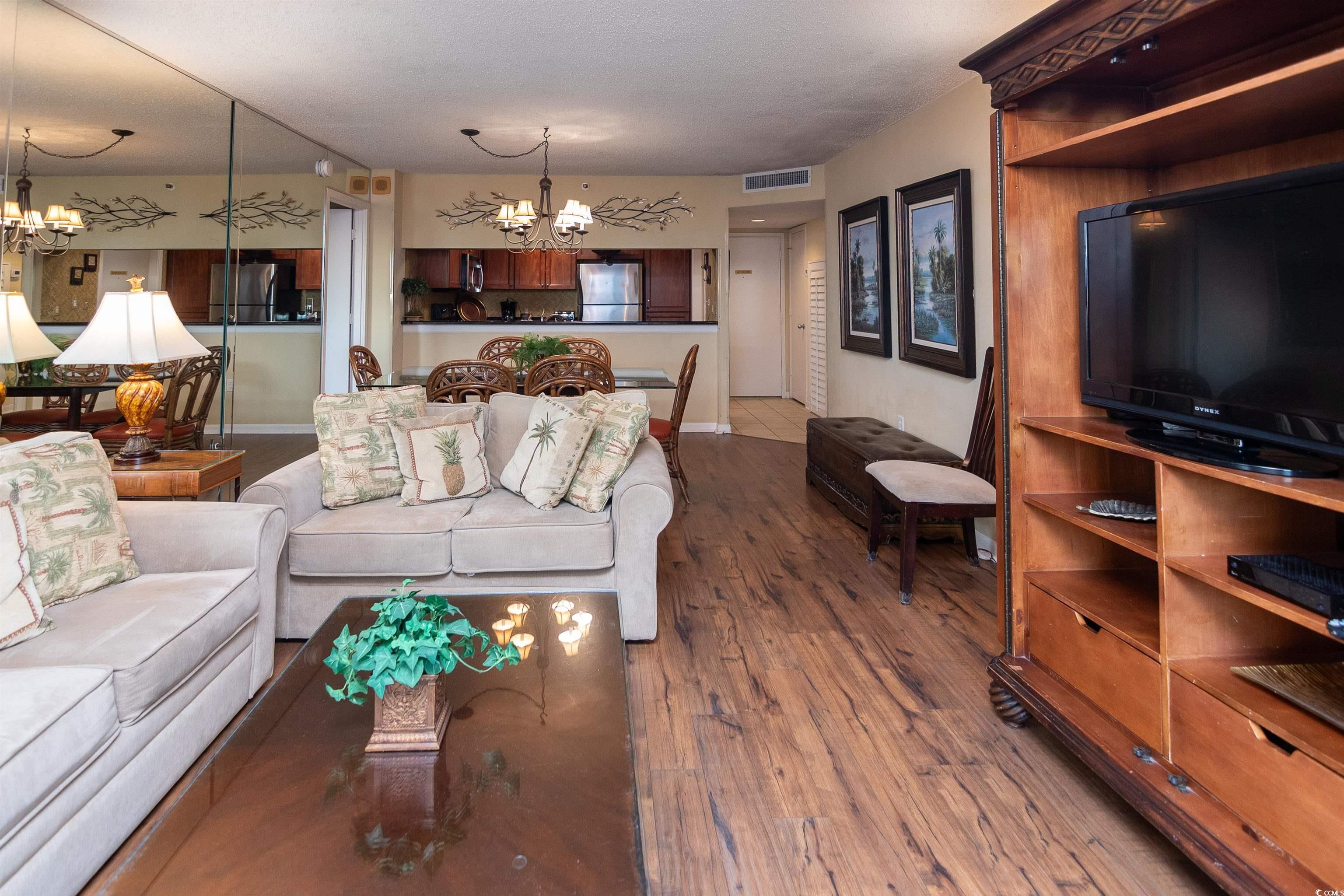9820 Queensway Boulevard, Unit 1006 Myrtle Beach, SC 29572 - Photo 14 of 30 Living area featuring a chandelier and wood finished floors