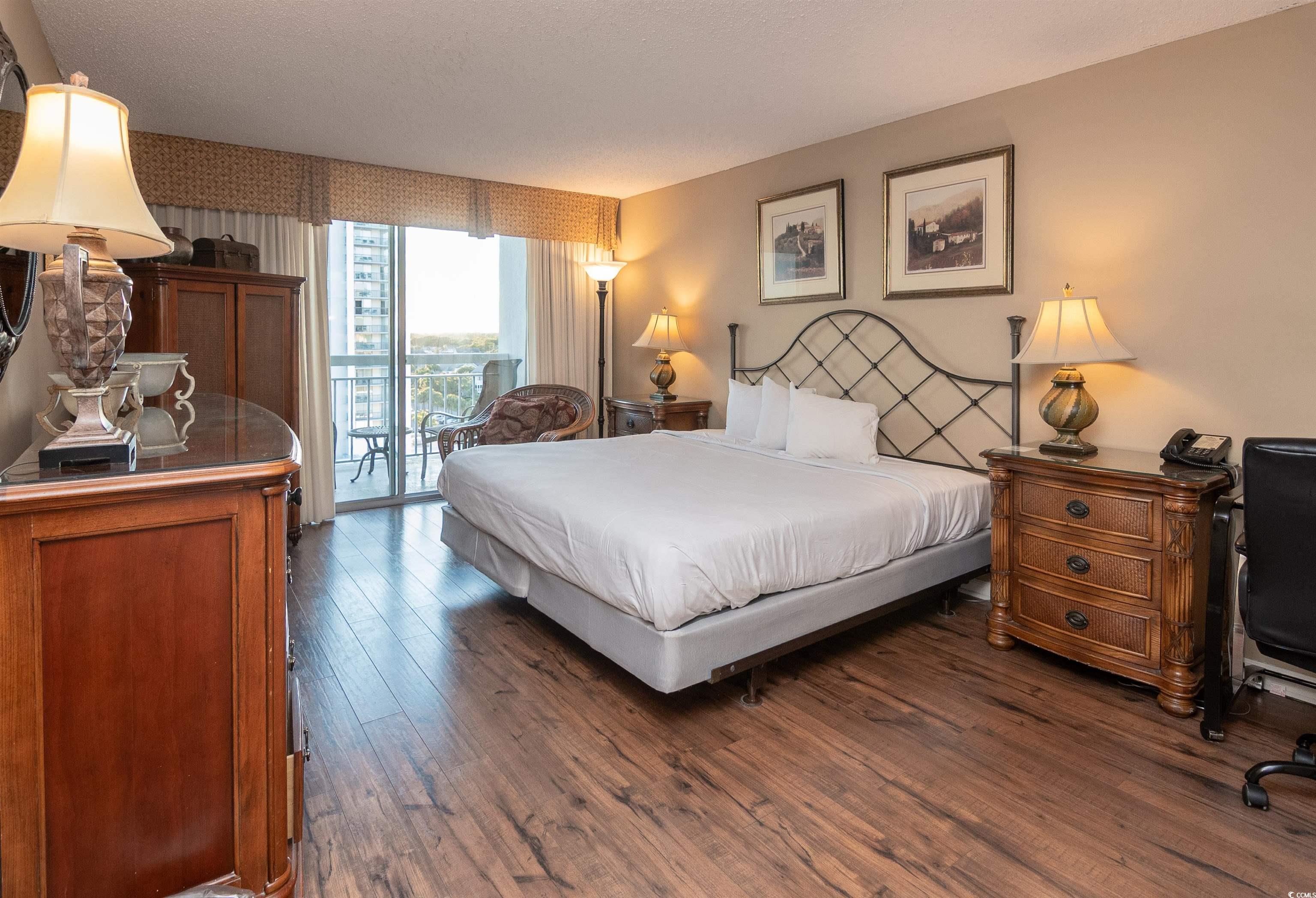 9820 Queensway Boulevard, Unit 1006 Myrtle Beach, SC 29572 - Photo 15 of 30 Bedroom with access to outside and dark wood-style flooring