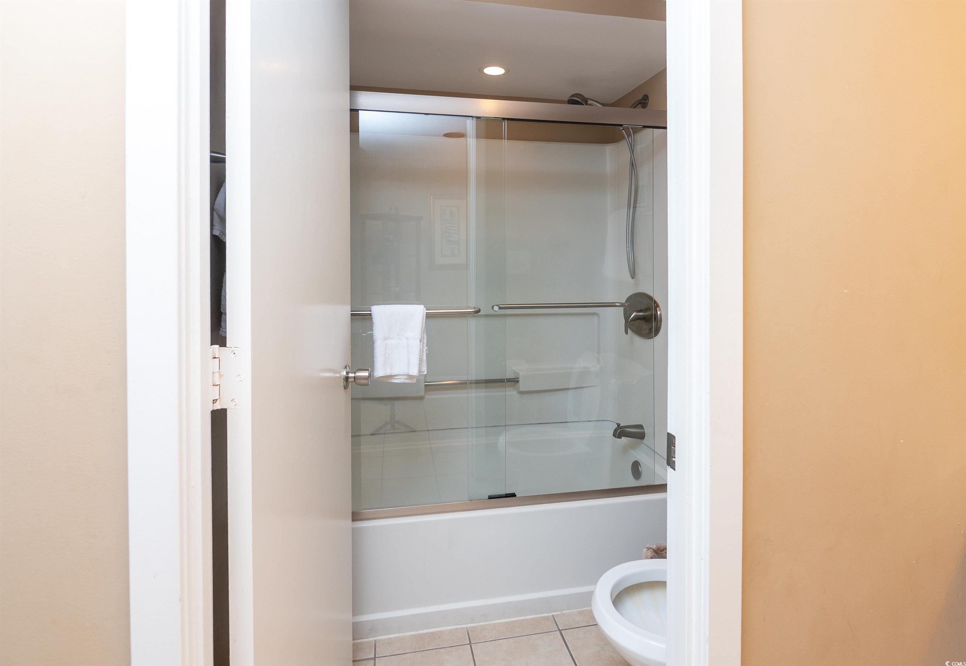 9820 Queensway Boulevard, Unit 1006 Myrtle Beach, SC 29572 - Photo 18 of 30 Full bath featuring light tile patterned floors, bath / shower combo with glass door, and recessed lighting