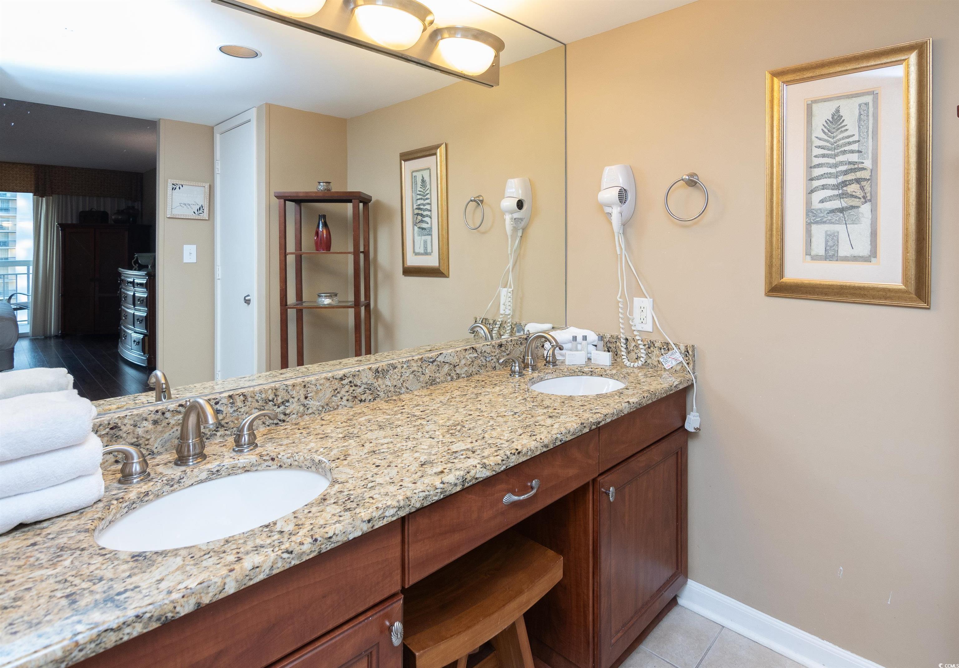 9820 Queensway Boulevard, Unit 1006 Myrtle Beach, SC 29572 - Photo 19 of 30 Bathroom with double vanity and light tile patterned floors