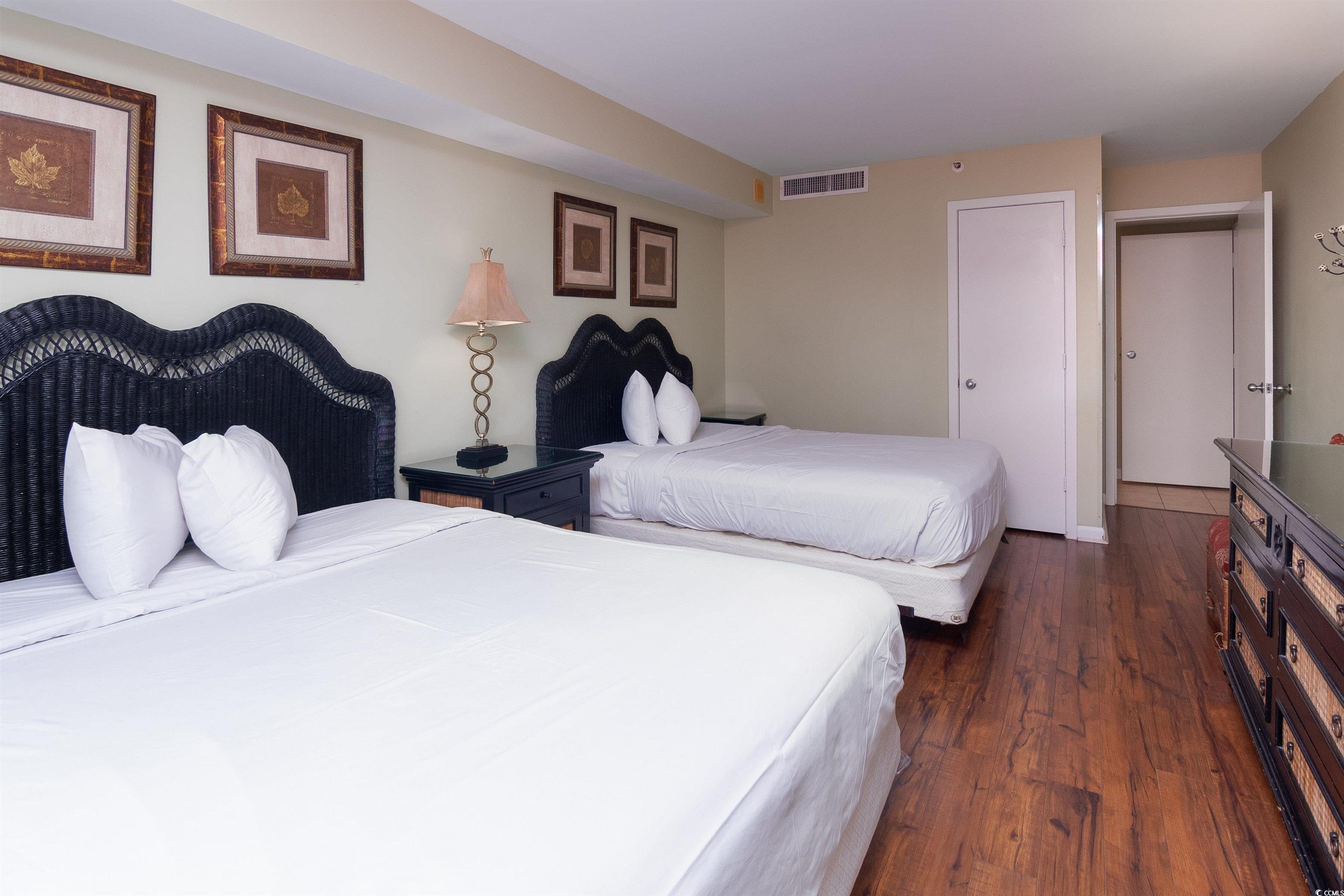 9820 Queensway Boulevard, Unit 1006 Myrtle Beach, SC 29572 - Photo 24 of 30 Bedroom featuring dark wood-style flooring