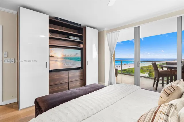 a bedroom with a bed and large windows