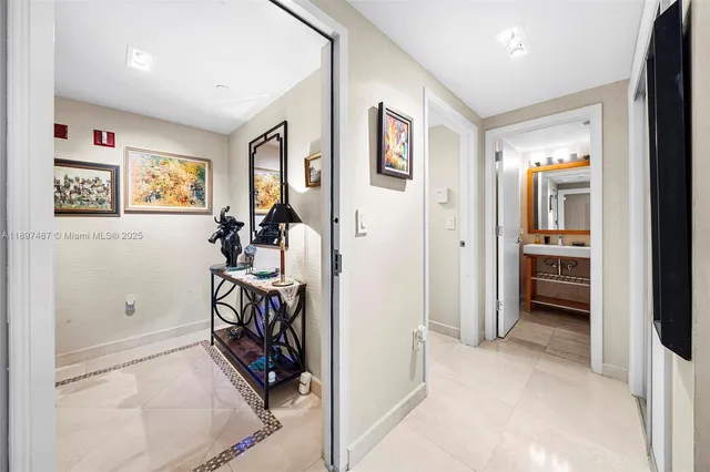 a view of a hallway with workspace and a living room